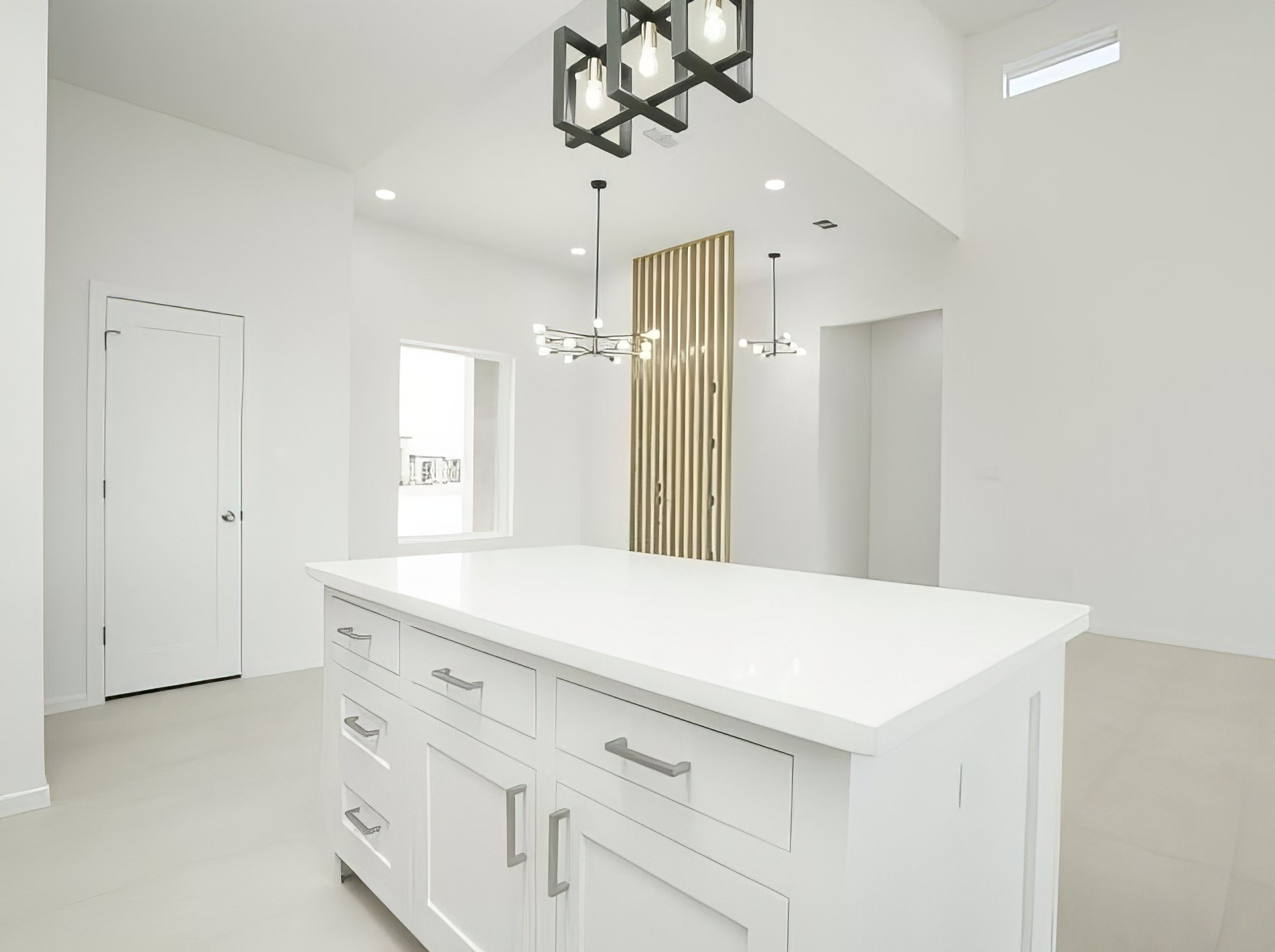 The Vincent · kitchen island with quartz waterfall edge and dual chandeliers
