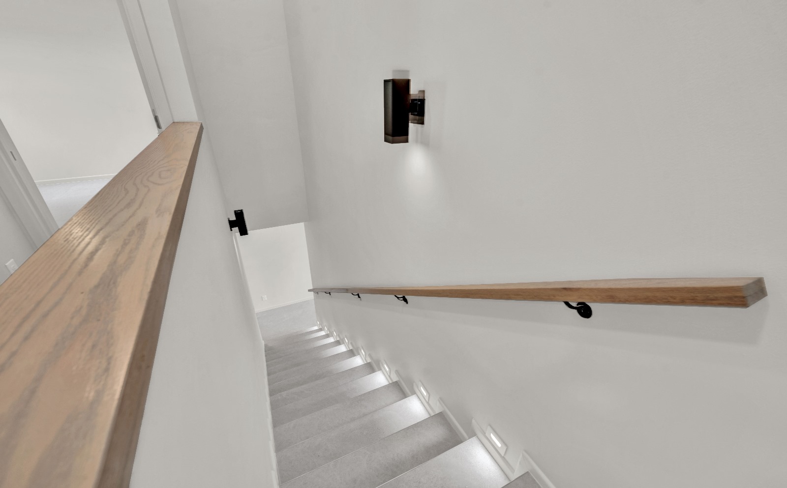 Bicentennial Townhouse · stair with wood handrail and lit treads