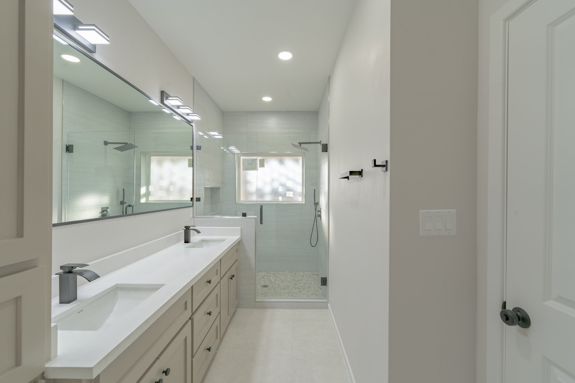 Three Sisters · primary bath with double vanity and walk in shower