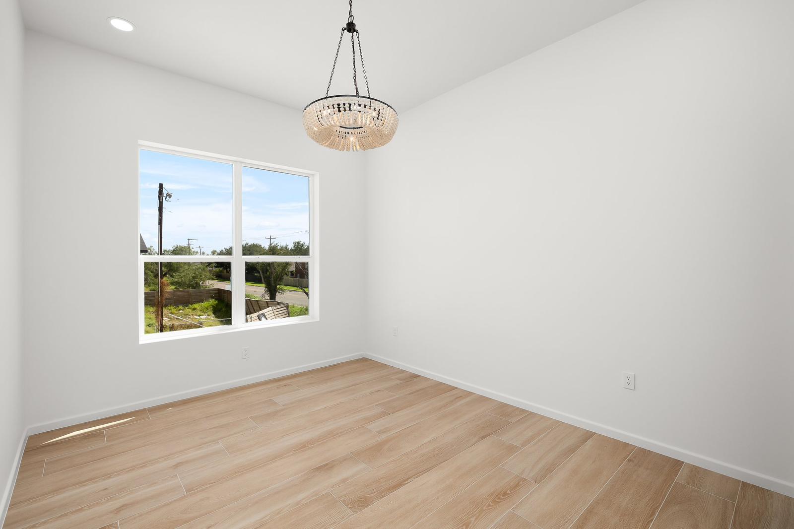 Cassandra Row · main bedroom with chandelier and view to backyard
