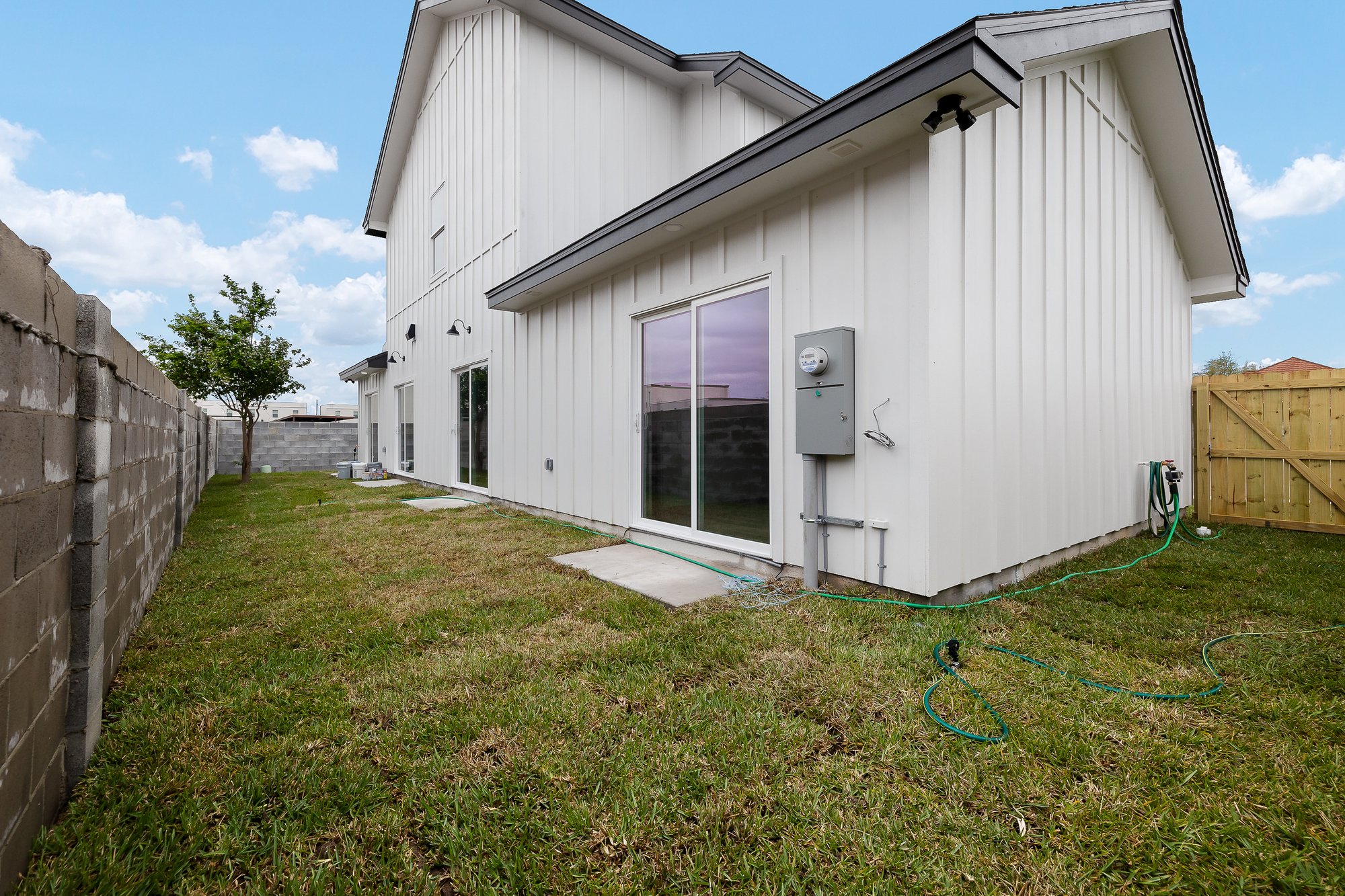 Stablewood · rear elevation with black trim and board and batten siding