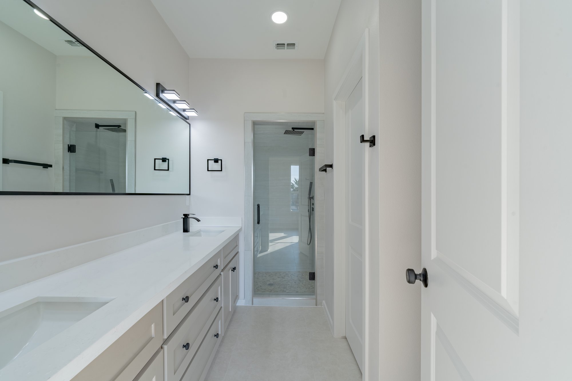 Three Sisters · secondary bath with tub shower combo and quartz vanity