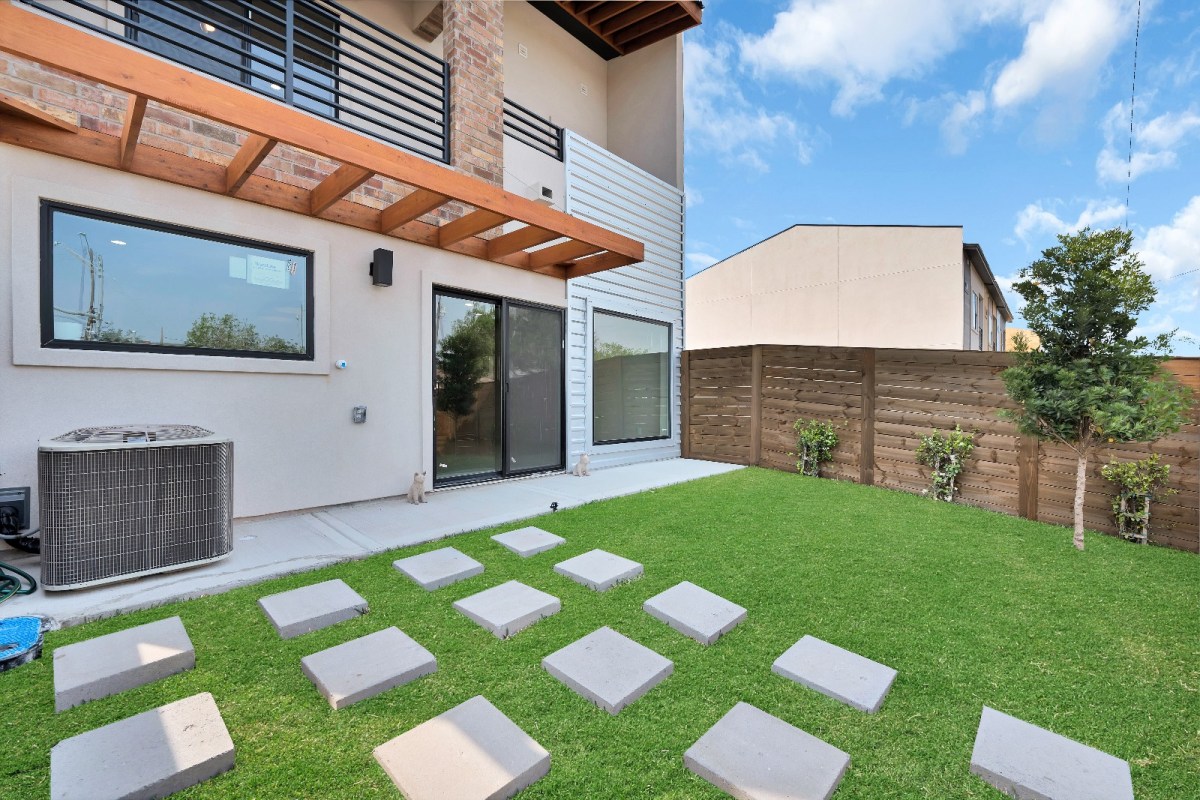 920 S Bicentennial rear elevation with paver patio, brick and stucco facade, upper balcony with pergola