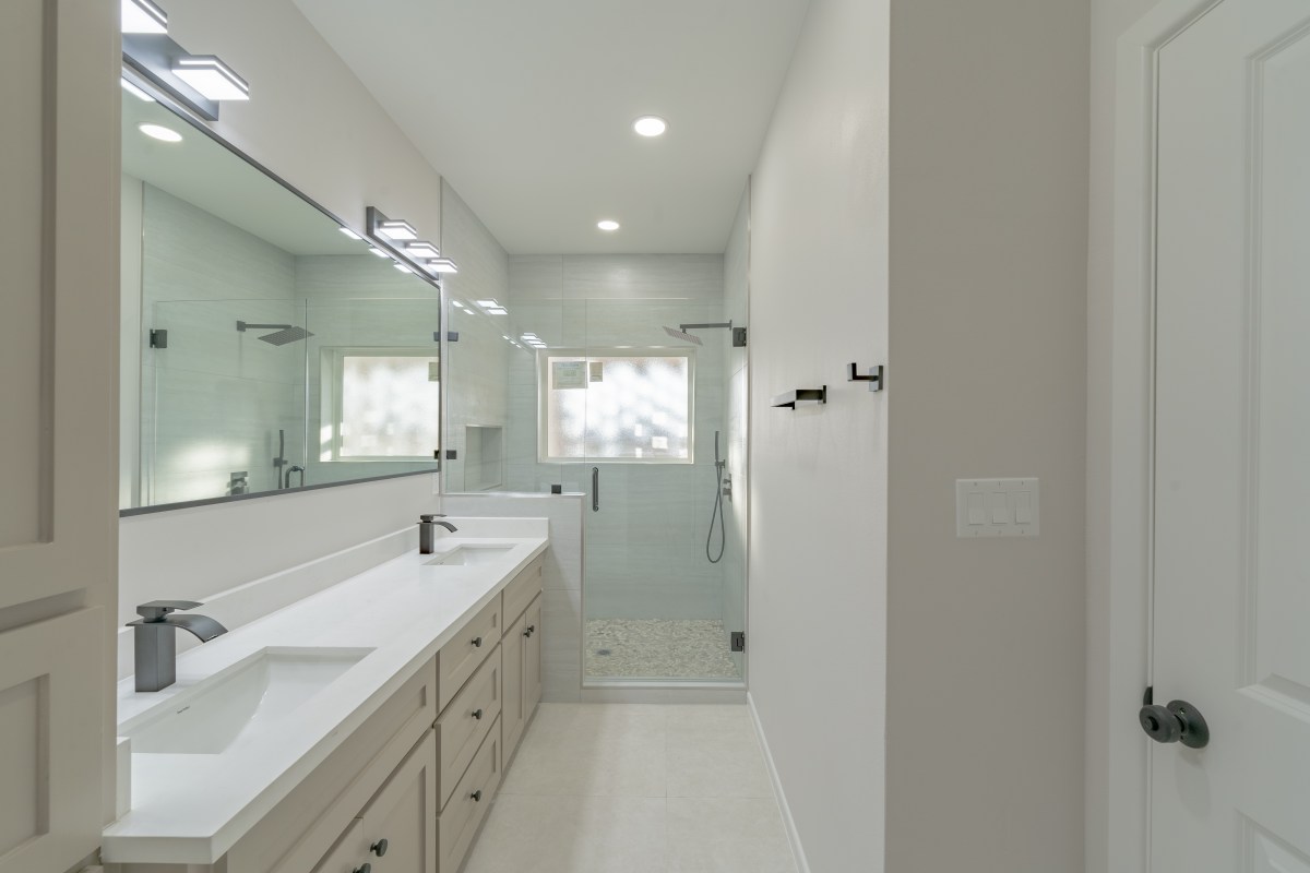 Three Sisters primary bath with double vanity and walk in shower