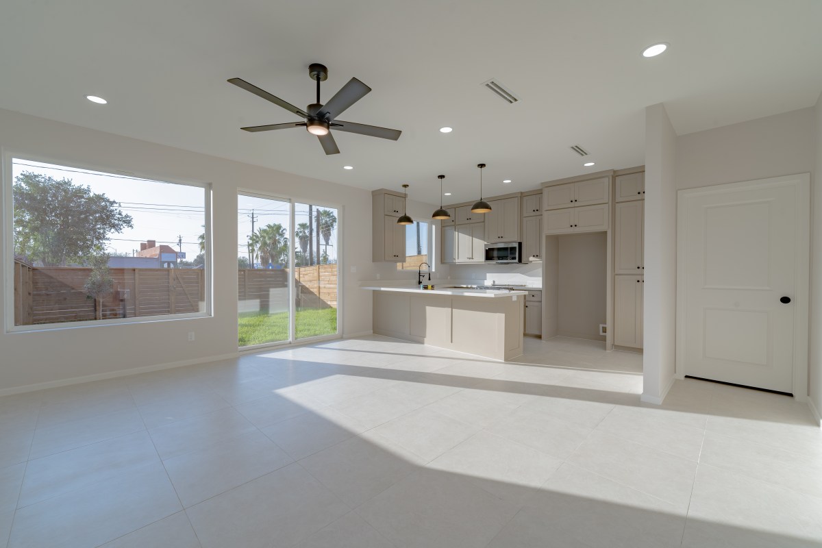 Three Sisters great room with sliding doors to back yard and kitchen at right